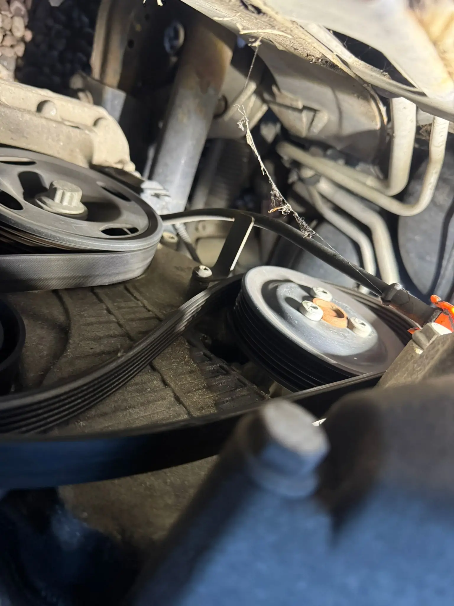 man servicing a car engine